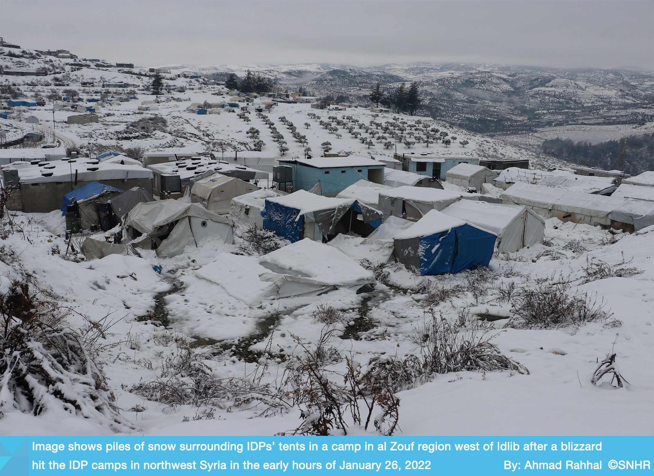 Exclusive image for SNHR shows piles of snow surrounding IDPs’ tents in a camp in west of Idlib 26-1-2022