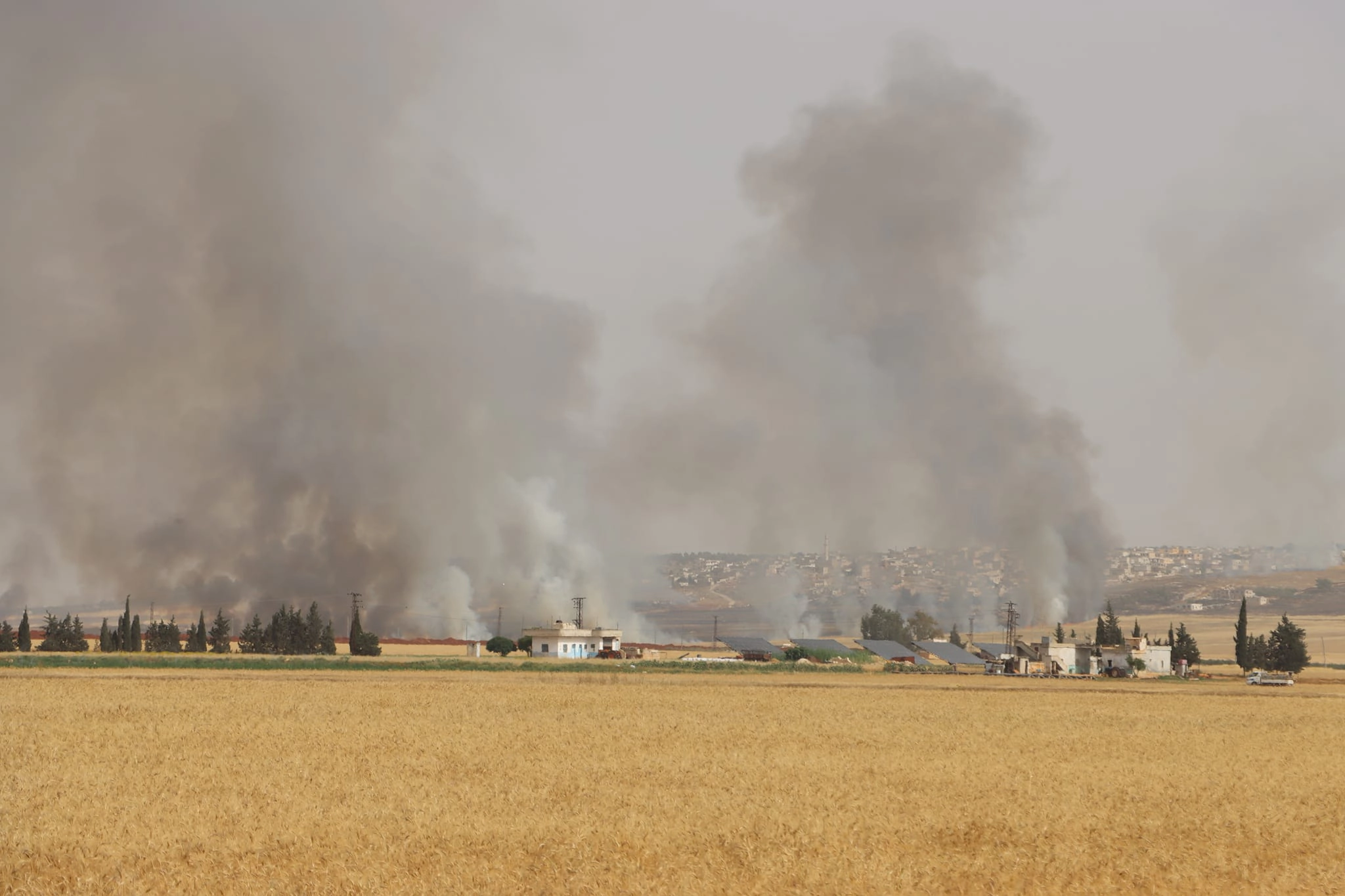 Syrian regime forces bomb agricultural land, burning crops, in western Aleppo suburbs, June 2, 2023