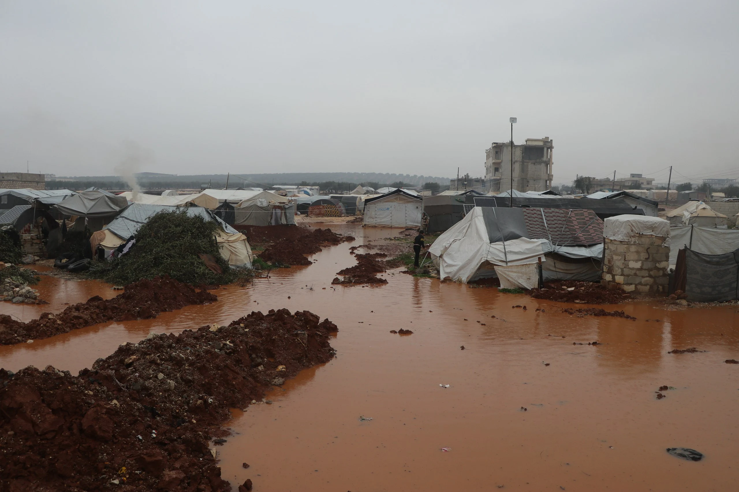water permeating 20 tents in al-Karam Camp near Jendeires town in the rural areas of Afrin city in northwestern Aleppo governorate